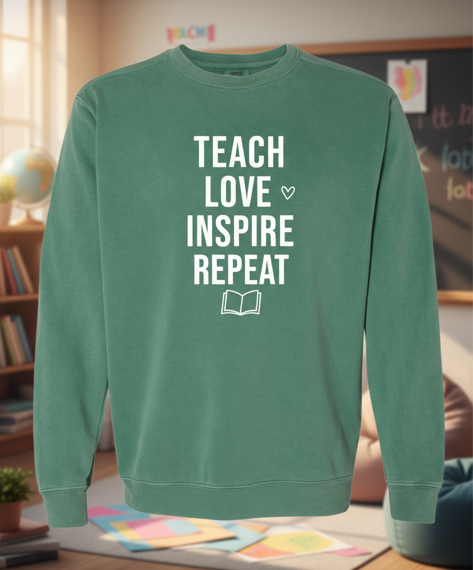Green sweatshirt with 'TEACH LOVE INSPIRE REPEAT' text on a white background