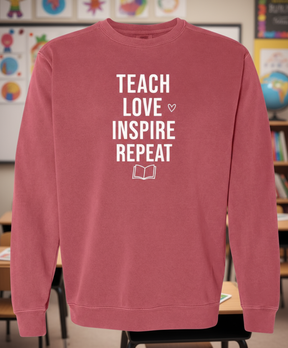 Maroon sweatshirt with 'TEACH LOVE INSPIRE REPEAT' text on a white background